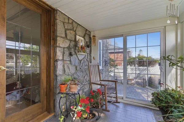 a view of entryway with wooden floor and dining room