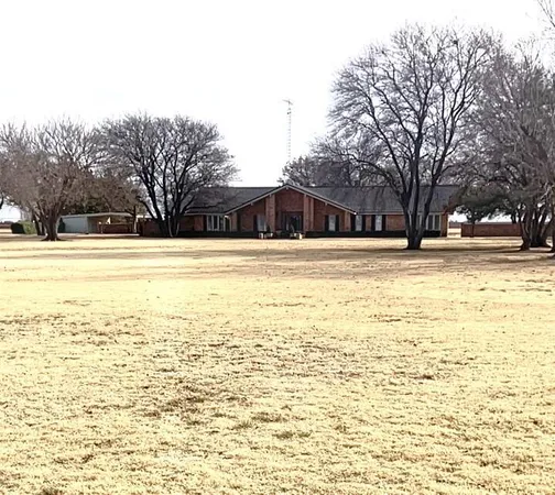 a view of yard with swimming pool and trees