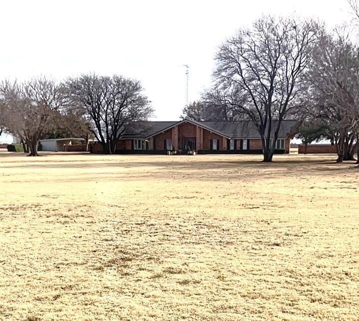 a view of yard with swimming pool and trees
