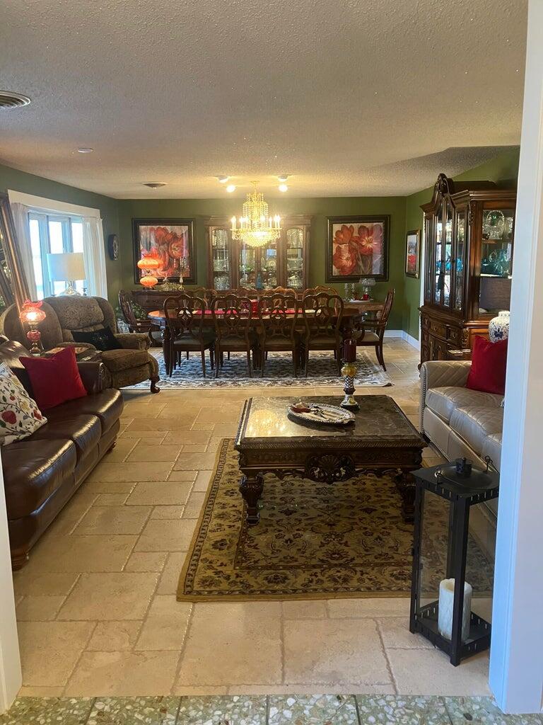 7303 Olton Road Plainview, TX 79072 - Photo 13 of 56 a living room with furniture a flat screen tv and a fireplace