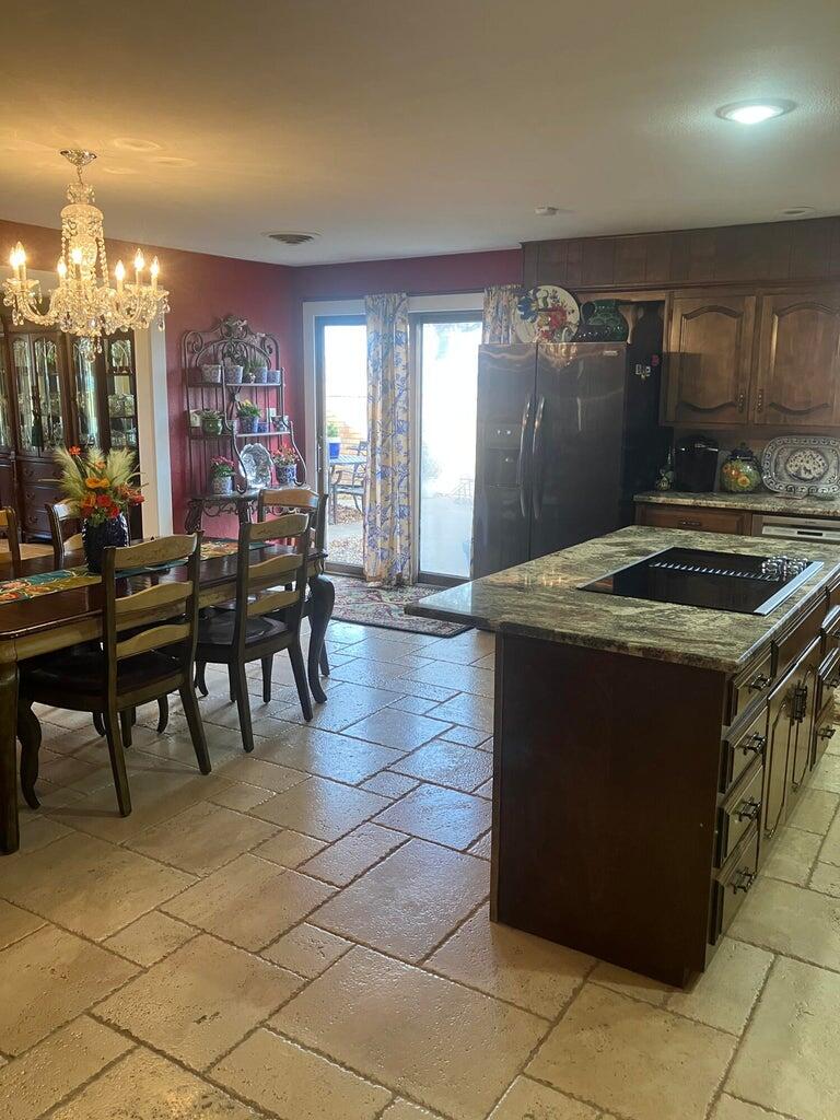 7303 Olton Road Plainview, TX 79072 - Photo 17 of 56 a kitchen with a table and chairs
