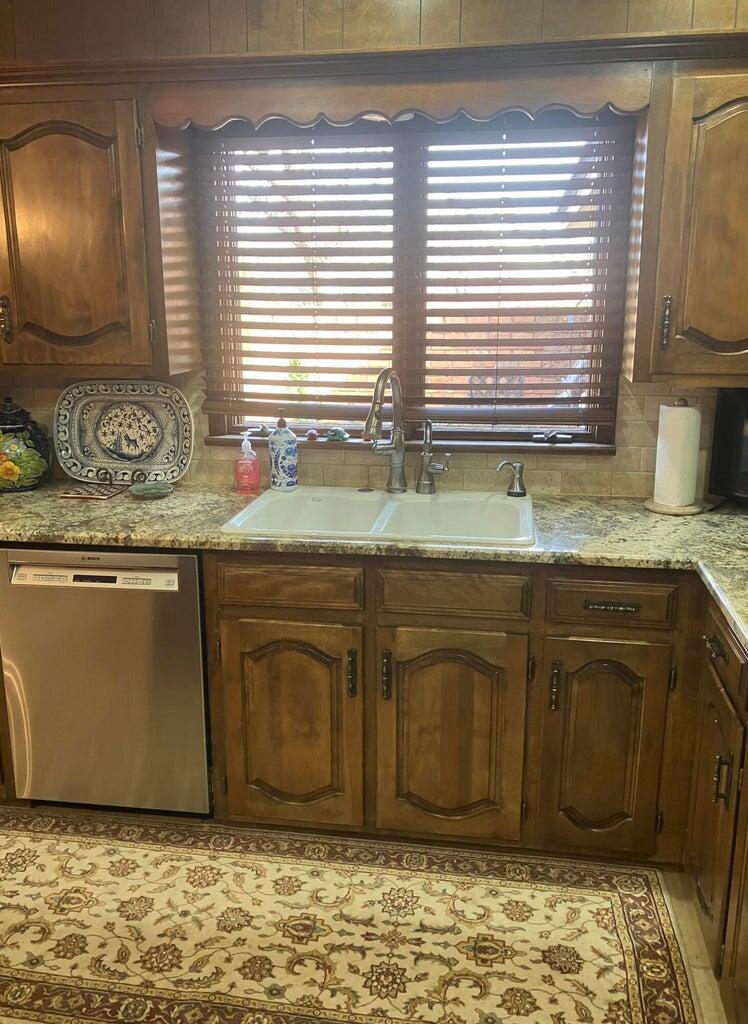7303 Olton Road Plainview, TX 79072 - Photo 19 of 56 a bathroom with a granite countertop sink and a mirror