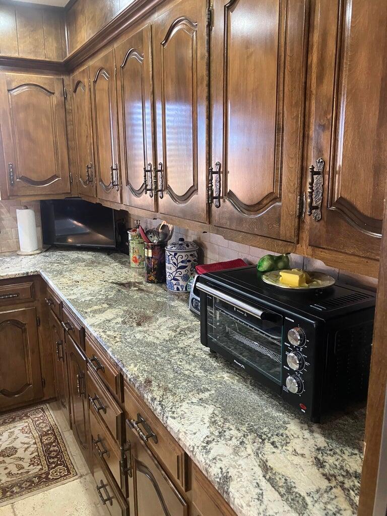 7303 Olton Road Plainview, TX 79072 - Photo 20 of 56 a bathroom with a granite countertop sink and a mirror