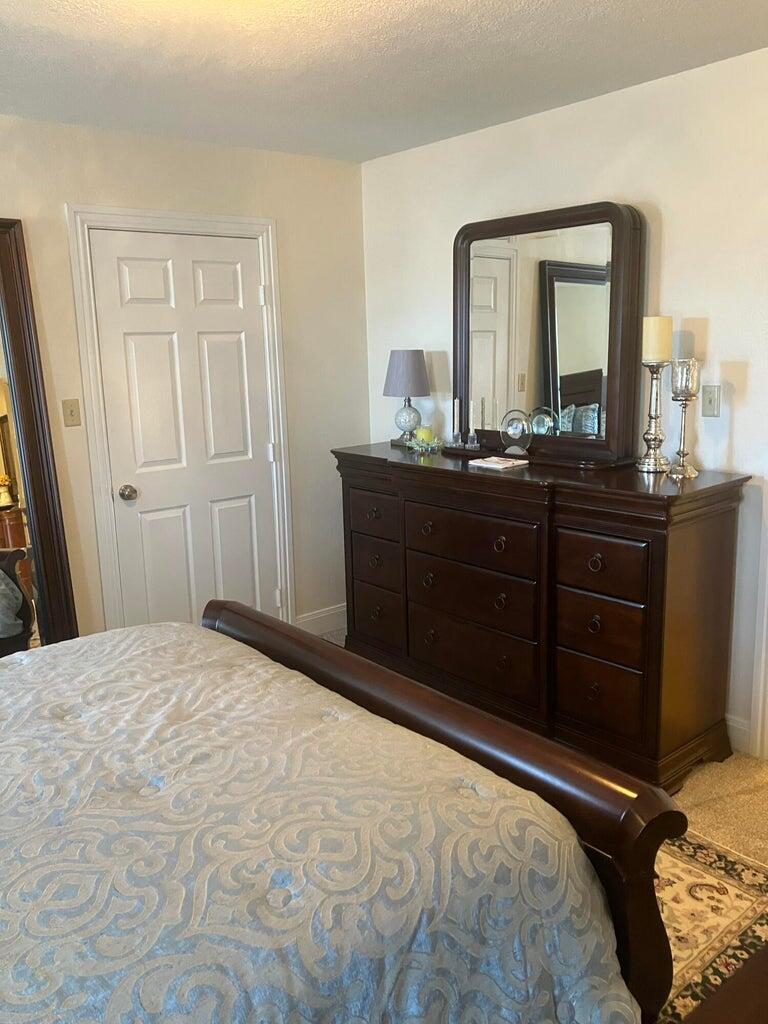 7303 Olton Road Plainview, TX 79072 - Photo 25 of 56 a bedroom with a bed and a mirror on dresser