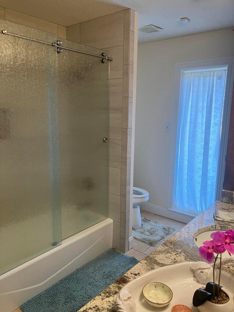 7303 Olton Road Plainview, TX 79072 - Photo 26 of 56 a bathroom with a tub and shower