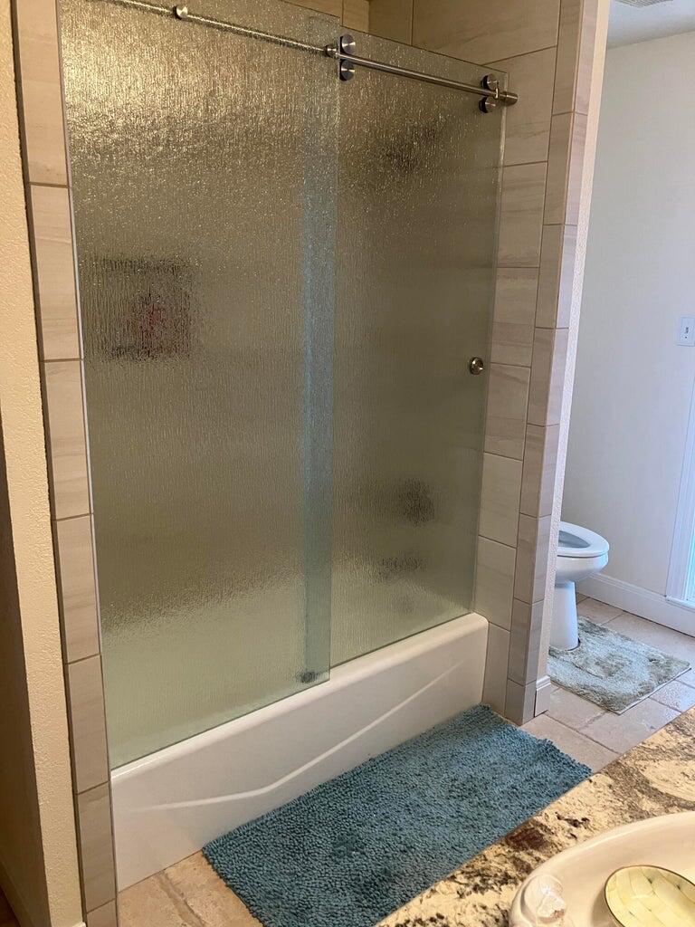 7303 Olton Road Plainview, TX 79072 - Photo 28 of 56 a bathroom with a shower and a toilet
