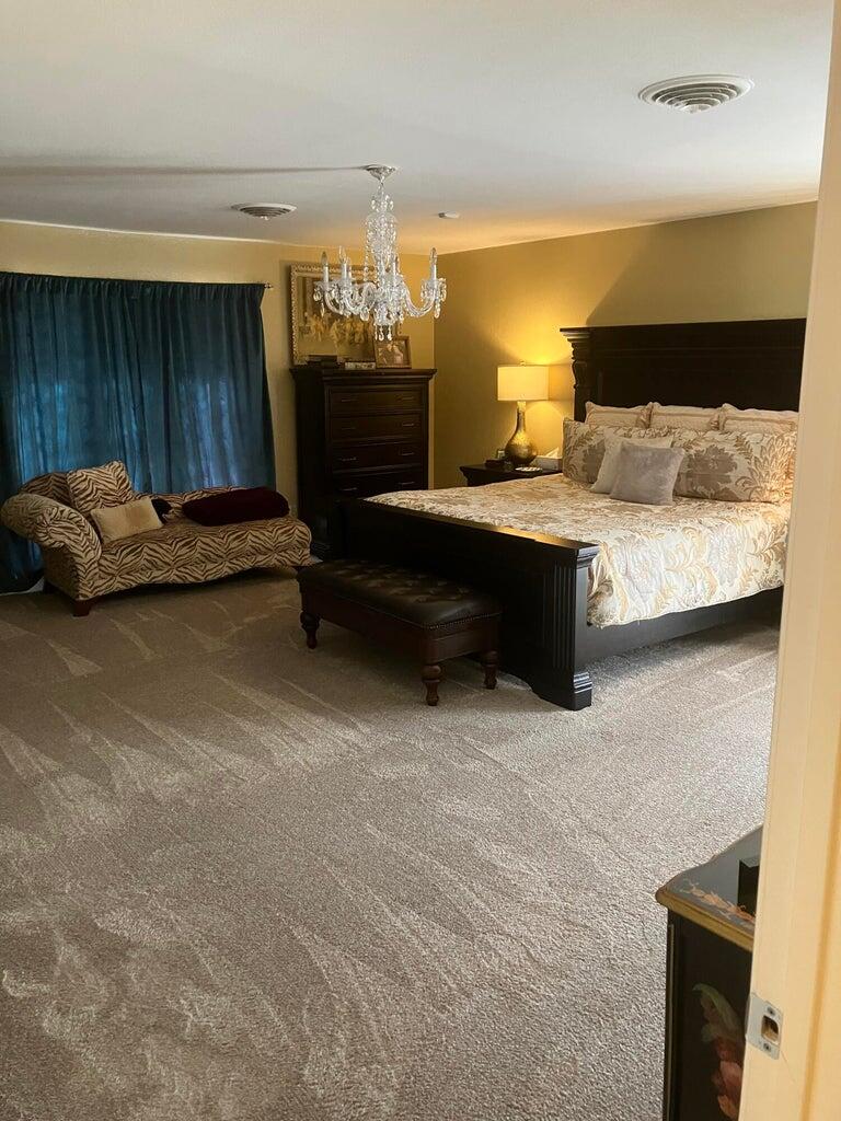 7303 Olton Road Plainview, TX 79072 - Photo 32 of 56 a bedroom with a bed and a table