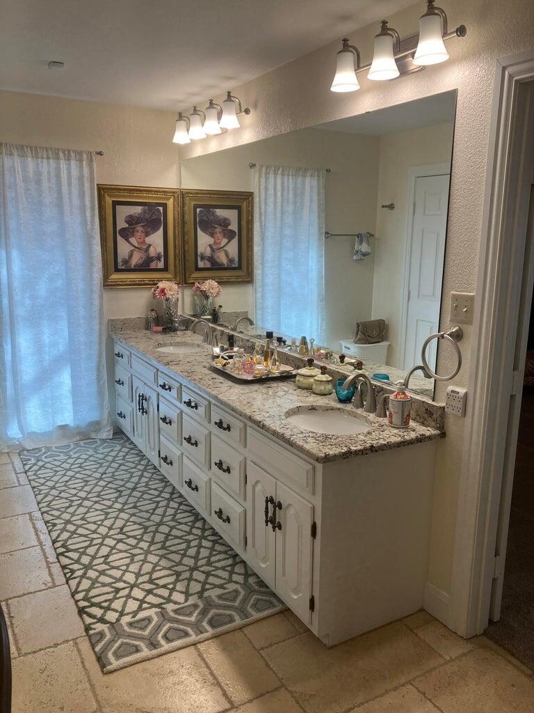 7303 Olton Road Plainview, TX 79072 - Photo 36 of 56 a bathroom with sink and mirror