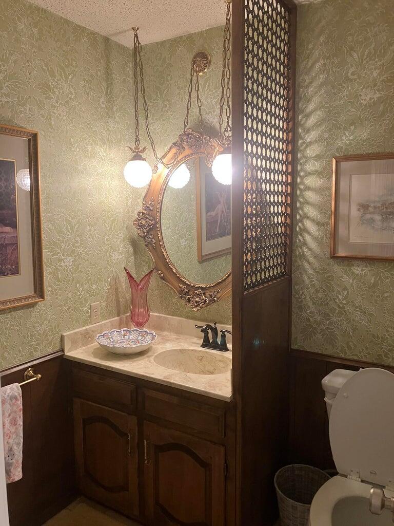 7303 Olton Road Plainview, TX 79072 - Photo 38 of 56 a bathroom with a sink mirror vanity and toilet