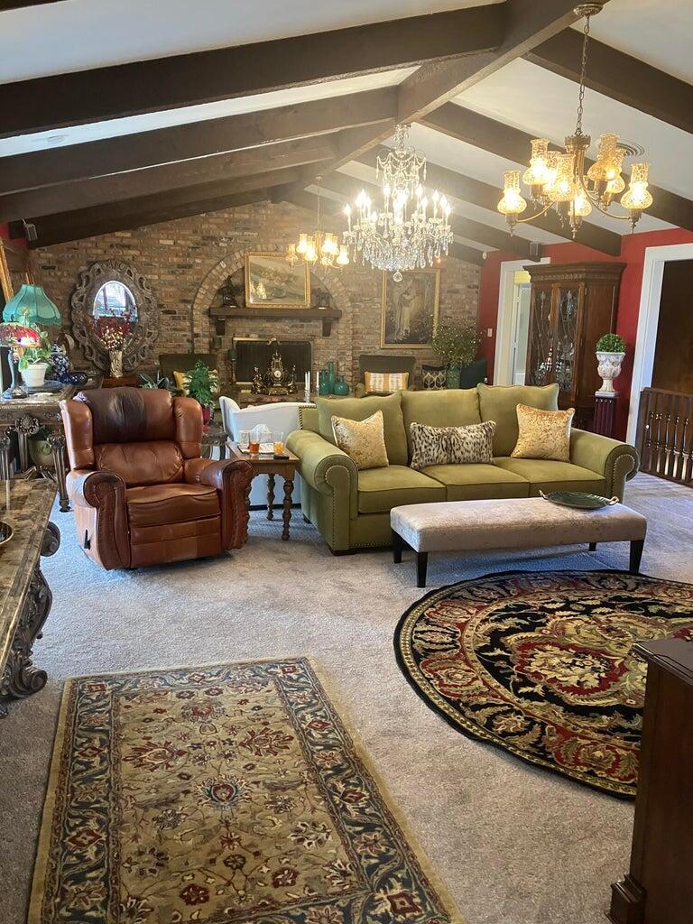 7303 Olton Road Plainview, TX 79072 - Photo 4 of 56 a living room with furniture and a chandelier