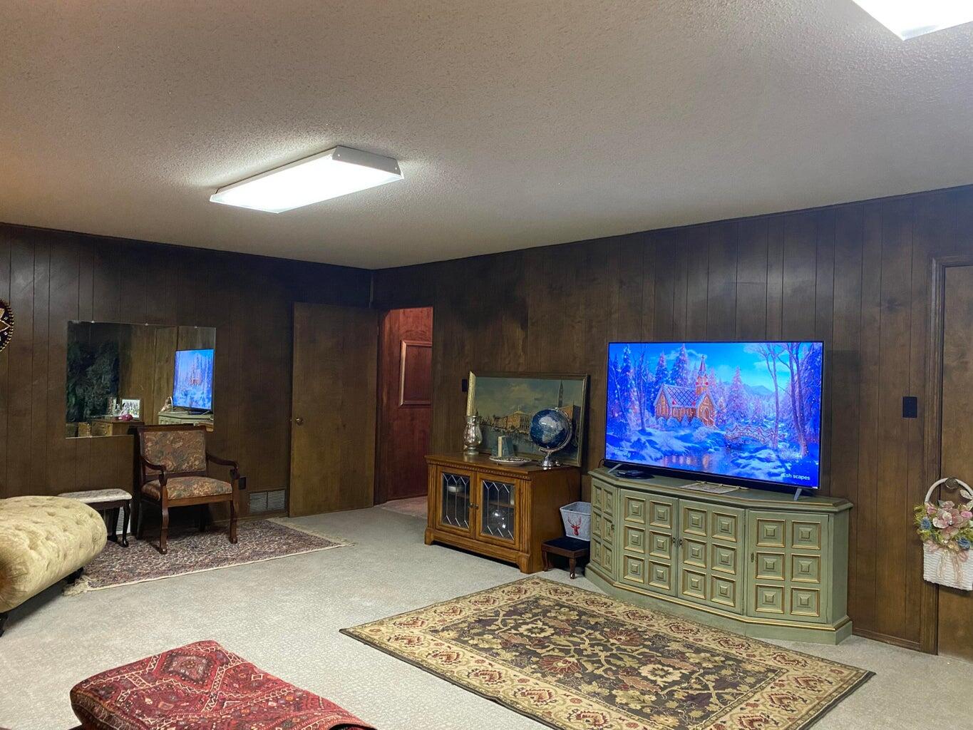 7303 Olton Road Plainview, TX 79072 - Photo 41 of 56 a living room with furniture flat screen tv and rug