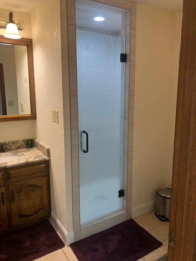 7303 Olton Road Plainview, TX 79072 - Photo 44 of 56 a bathroom with a granite countertop sink and a mirror