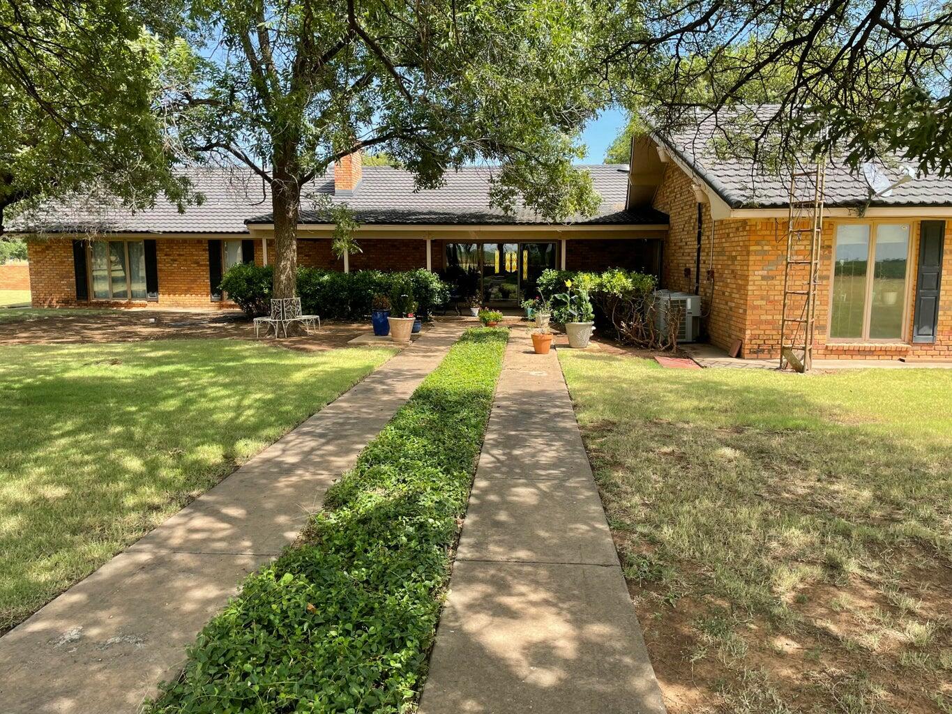 7303 Olton Road Plainview, TX 79072 - Photo 53 of 56 a front view of a house with yard porch and furniture