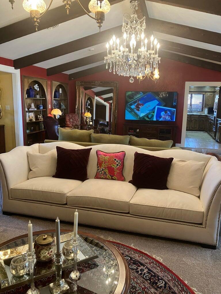 7303 Olton Road Plainview, TX 79072 - Photo 10 of 56 a living room with furniture and a chandelier