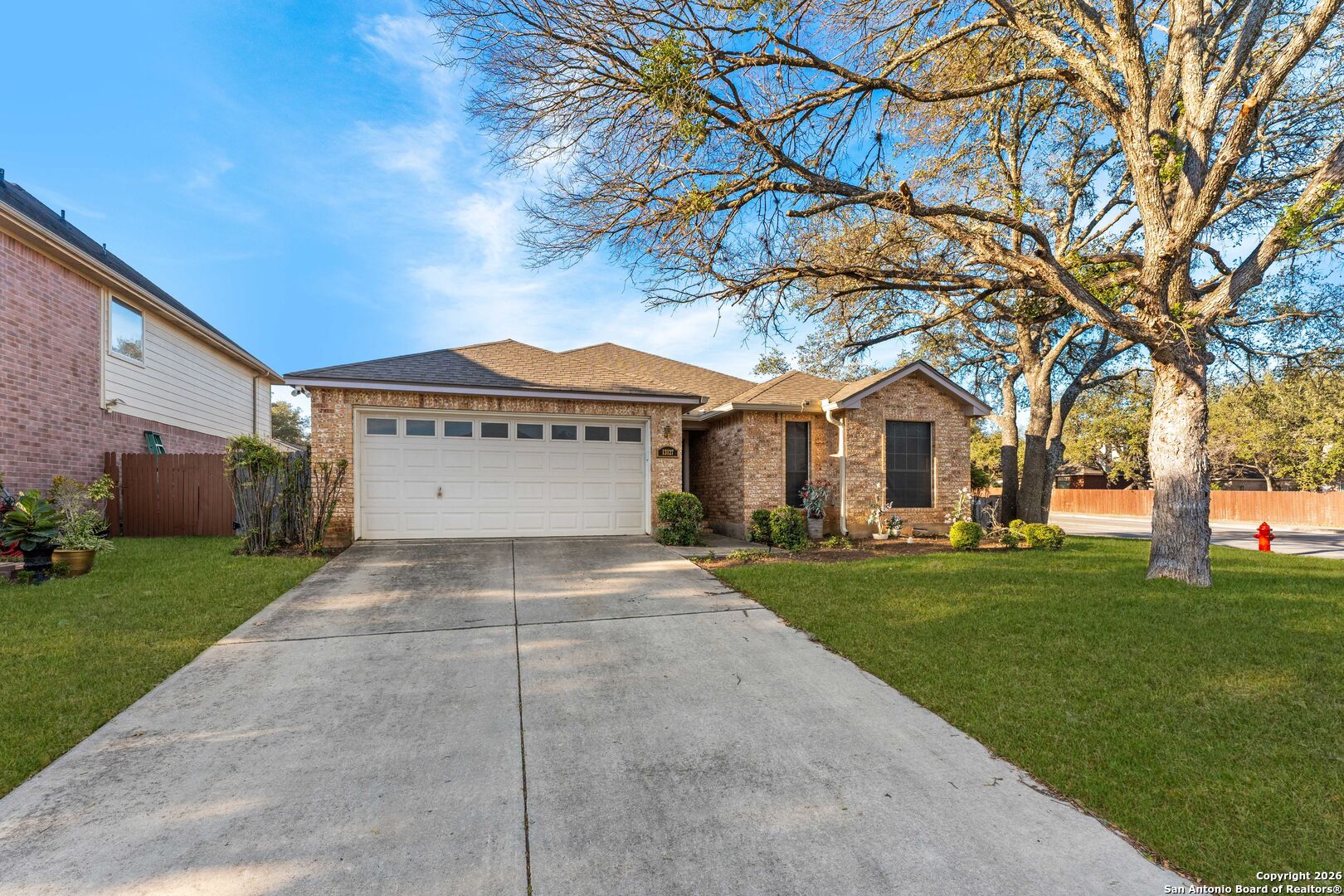 13127 Forum Universal City, TX 78148 - Photo 2 of 33 a view of house with a yard and garage