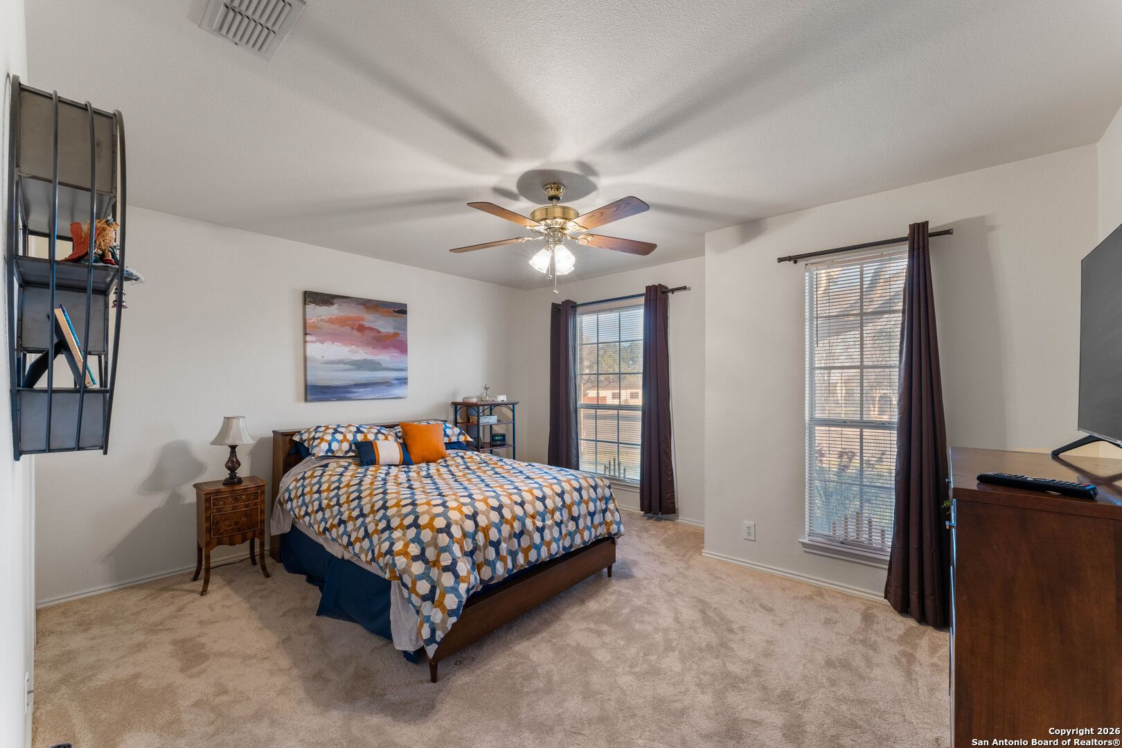 13127 Forum Universal City, TX 78148 - Photo 23 of 33 a bedroom with a bed and a chandelier