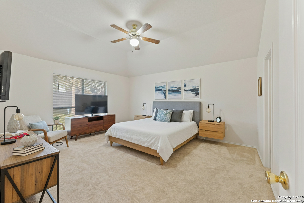 13127 Forum Universal City, TX 78148 - Photo 26 of 33 a spacious bedroom with a bed and a flat screen tv