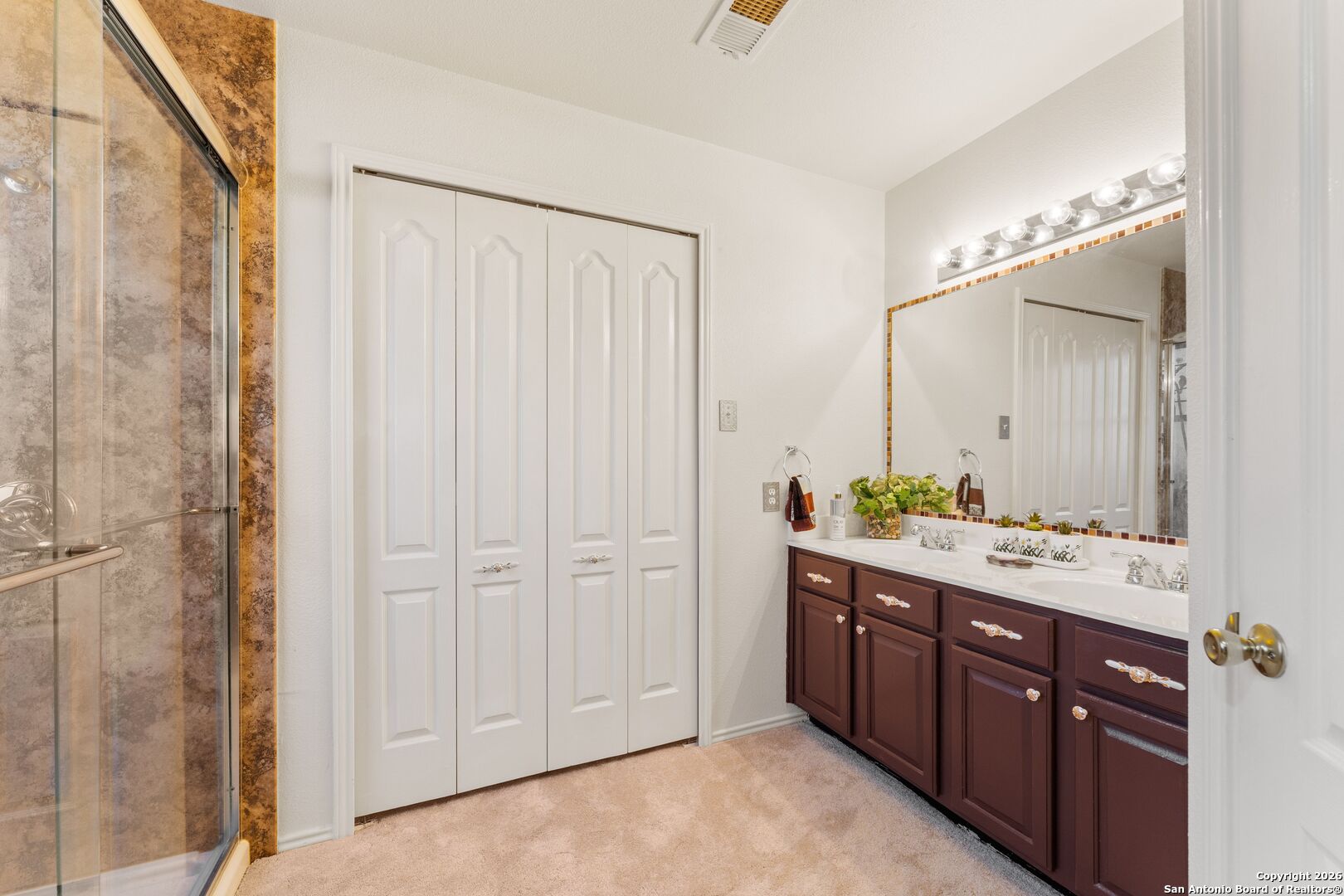 13127 Forum Universal City, TX 78148 - Photo 27 of 33 a spacious bathroom with a double vanity sink and a mirror