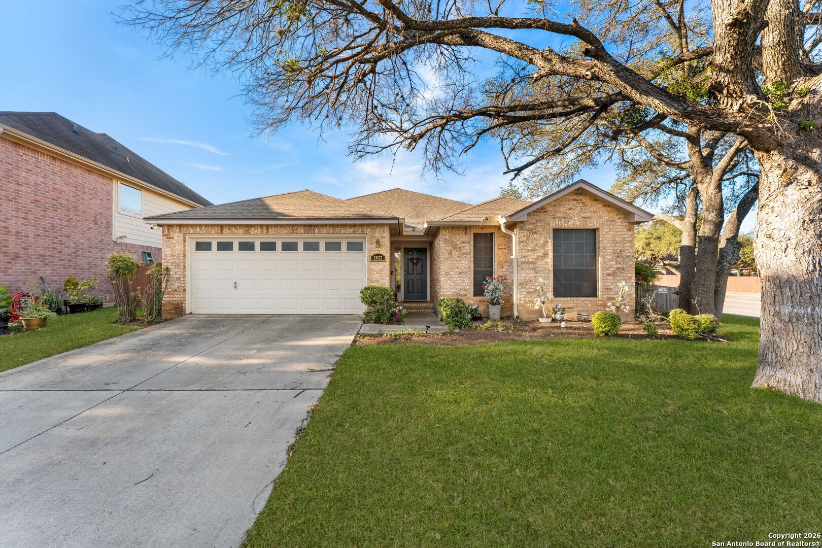 13127 Forum Universal City, TX 78148 - Photo 33 of 33 a front view of a house with a yard and garage