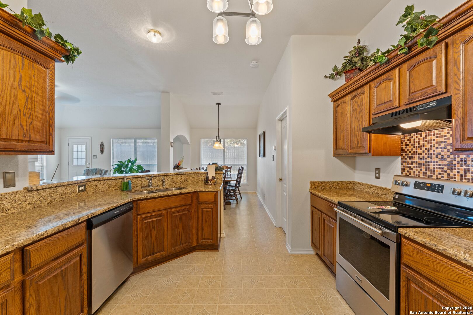 13127 Forum Universal City, TX 78148 - Photo 9 of 33 a kitchen with stainless steel appliances granite countertop a sink a stove and a refrigerator