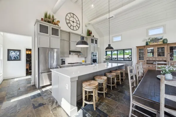 a large kitchen with a table and chairs