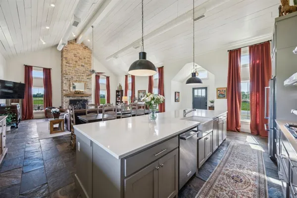 a large kitchen with kitchen island a large island in the center