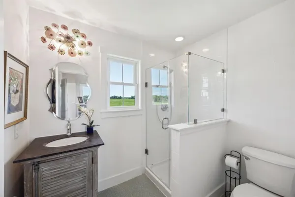 a bathroom with a sink mirror and toilet