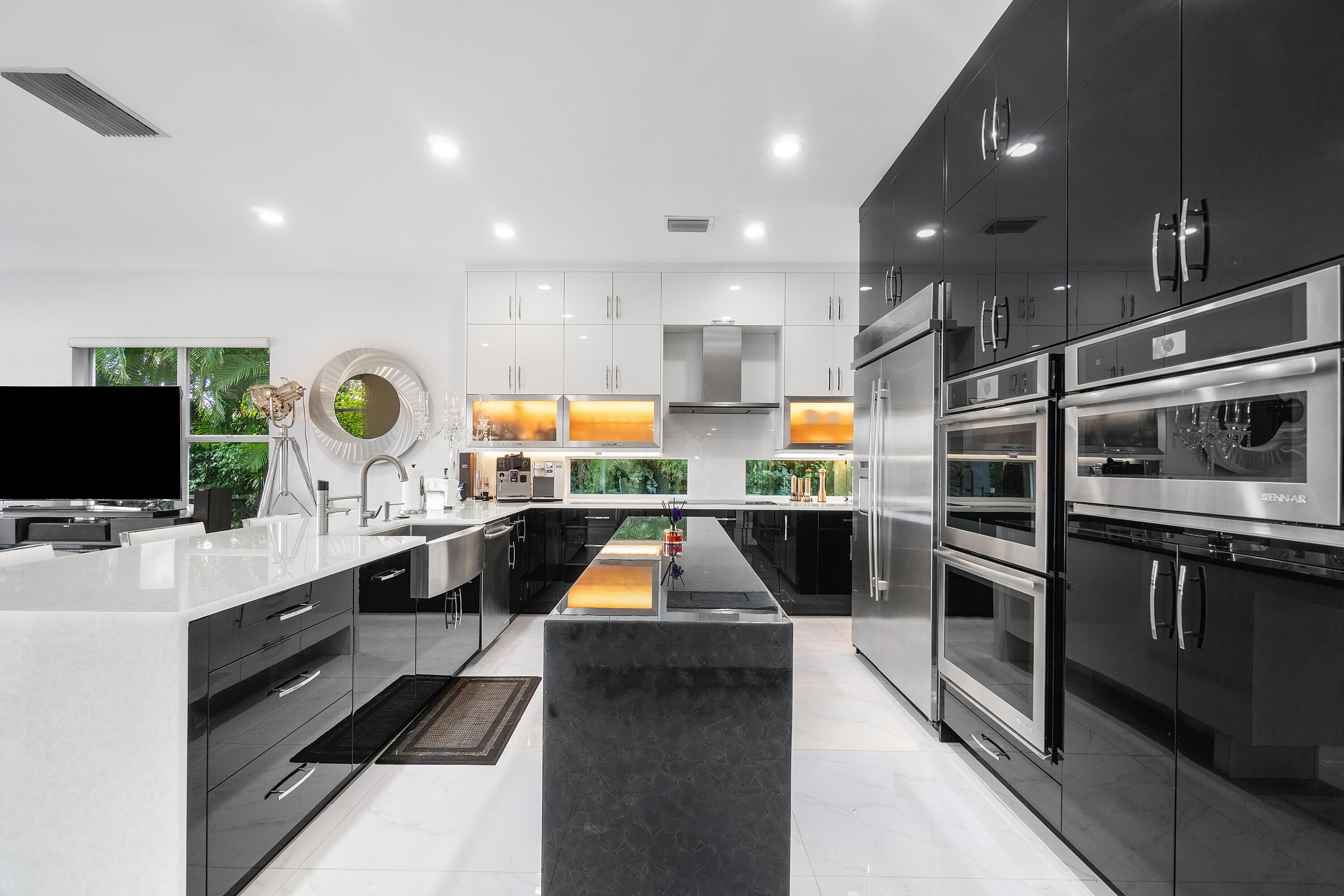 5447 Center Street Jupiter, FL 33458 - Photo 12 of 60 a kitchen with stainless steel appliances kitchen island granite countertop a stove and a sink