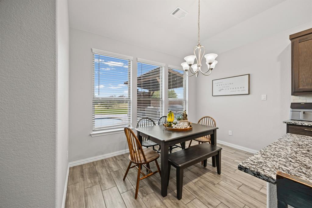 5405 Ranger Drive Midlothian, TX 76065 - Photo 14 of 29 Dining space with wood tiled floors and a chandelier