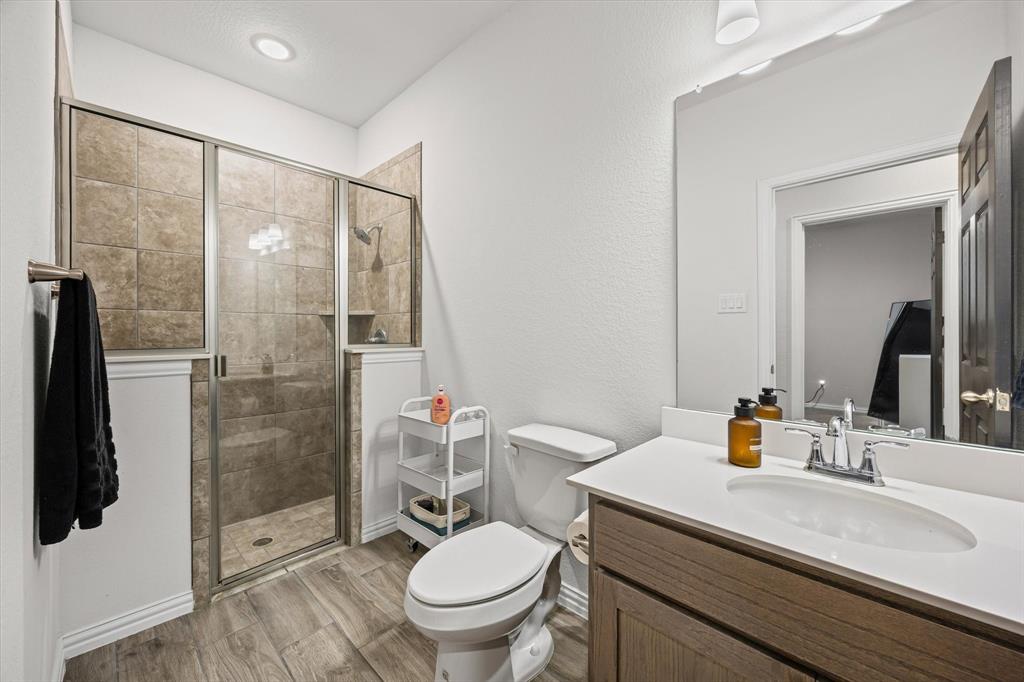 5405 Ranger Drive Midlothian, TX 76065 - Photo 25 of 29 Full bath with vanity, a shower stall, light wood-style flooring, and recessed lighting