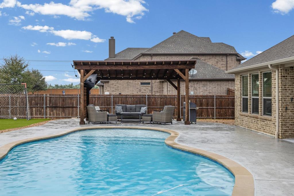 5405 Ranger Drive Midlothian, TX 76065 - Photo 28 of 29 View of swimming pool featuring an outdoor hangout area, a fenced backyard, a patio, area for grilling, and a pergola