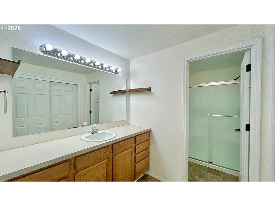 19504 Southwest Stacey Street Beaverton, OR 97003 - Photo 13 of 16 a bathroom with a sink a double vanity and a mirror