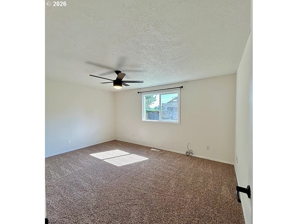 19504 Southwest Stacey Street Beaverton, OR 97003 - Photo 14 of 16 a view of an empty room with a window