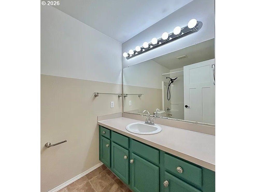 19504 Southwest Stacey Street Beaverton, OR 97003 - Photo 15 of 16 a bathroom with a double vanity sink and a mirror