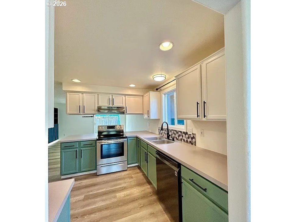 19504 Southwest Stacey Street Beaverton, OR 97003 - Photo 8 of 16 a kitchen with stainless steel appliances granite countertop a sink and cabinets