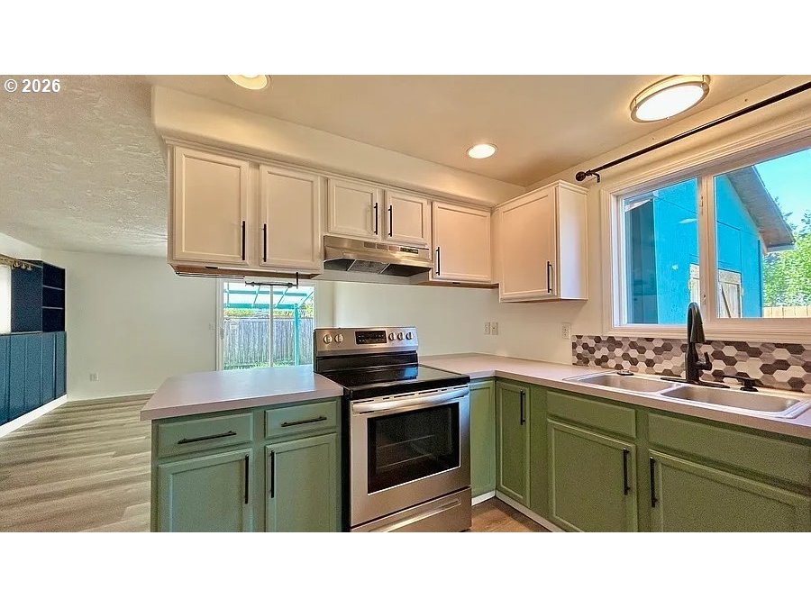19504 Southwest Stacey Street Beaverton, OR 97003 - Photo 10 of 16 a kitchen with a cabinets and white appliances