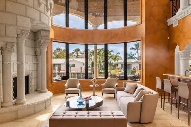 a living room with patio furniture and a flat screen tv