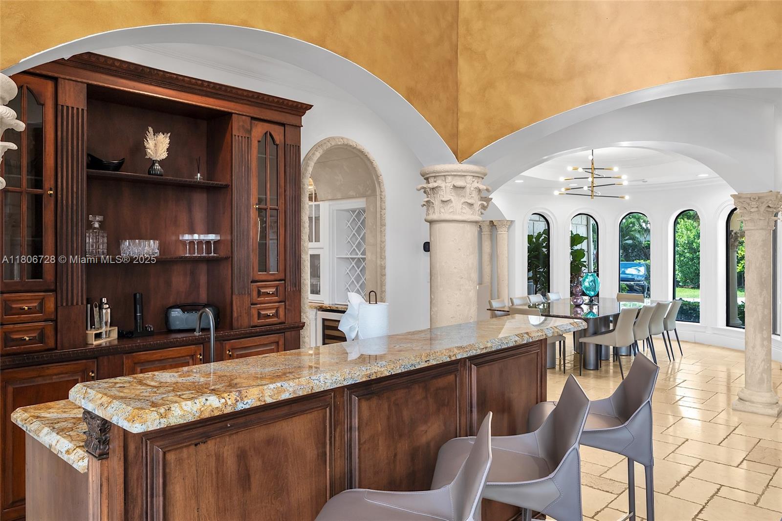 1011 Rhodes Villa Avenue Delray Beach, FL 33483 - Photo 18 of 90 a large white kitchen with a large window and stainless steel appliances