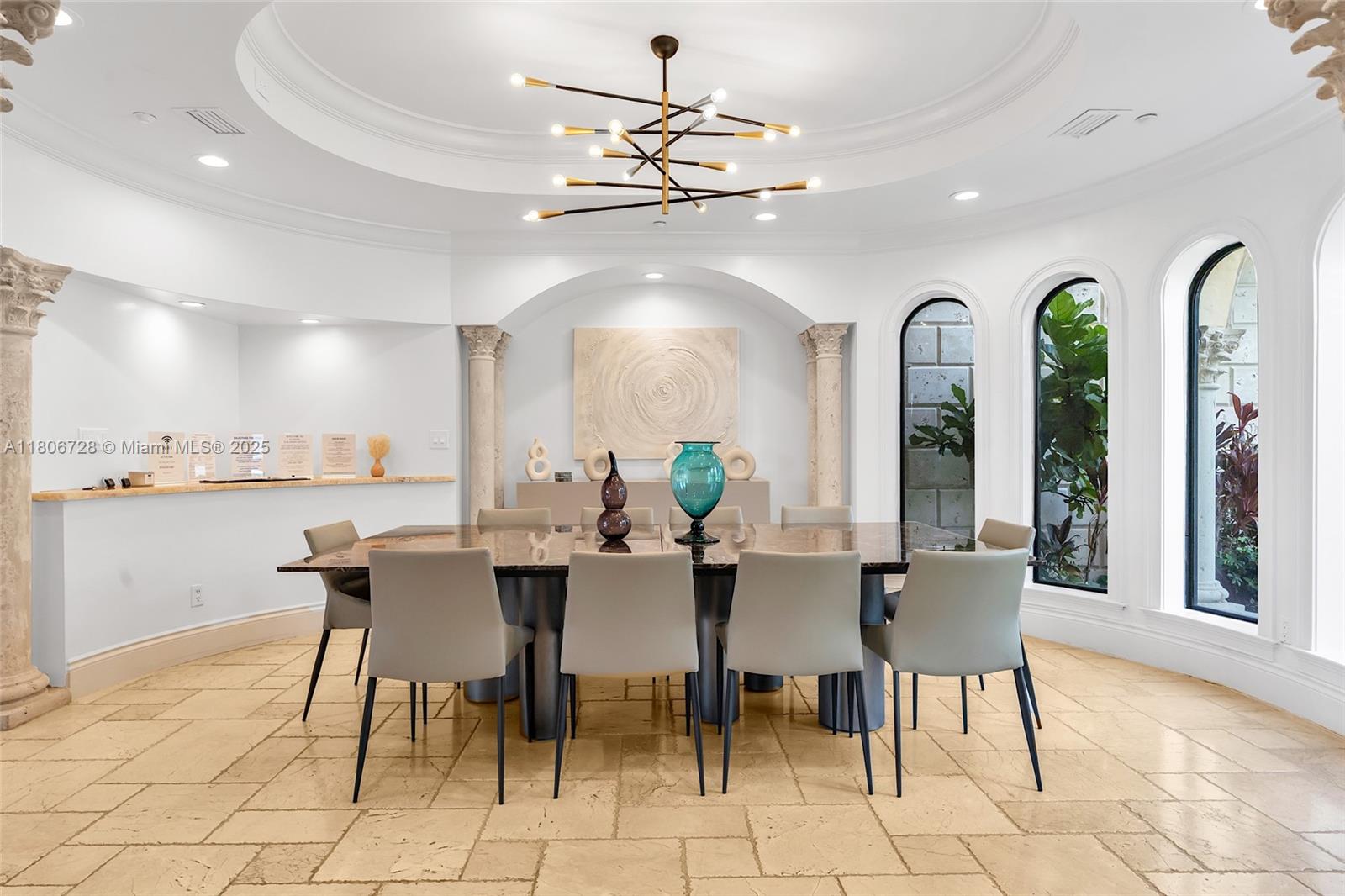 1011 Rhodes Villa Avenue Delray Beach, FL 33483 - Photo 20 of 90 a view of a dining room with furniture and chandelier