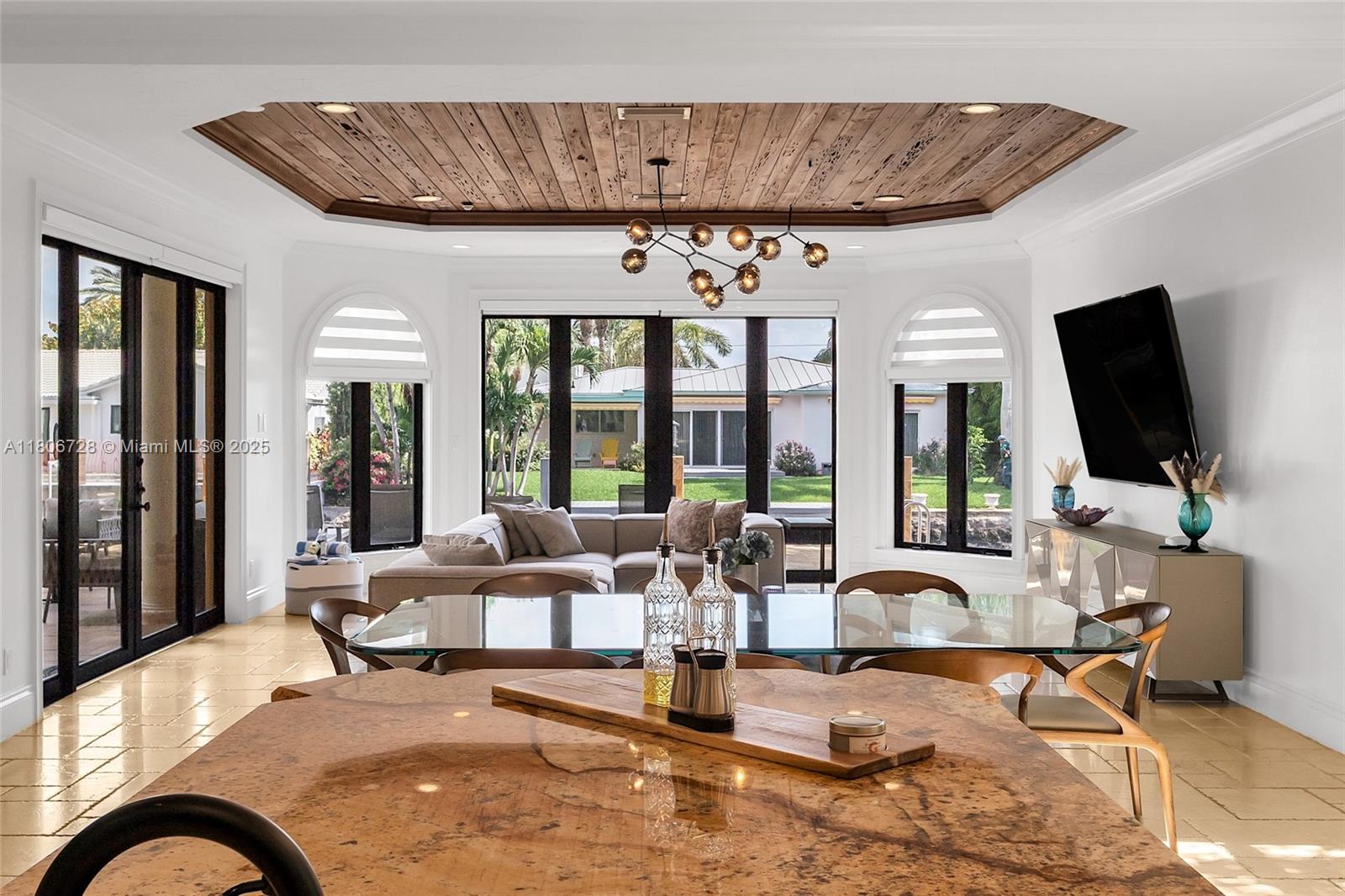 1011 Rhodes Villa Avenue Delray Beach, FL 33483 - Photo 23 of 90 a living room with patio furniture and a flat screen tv