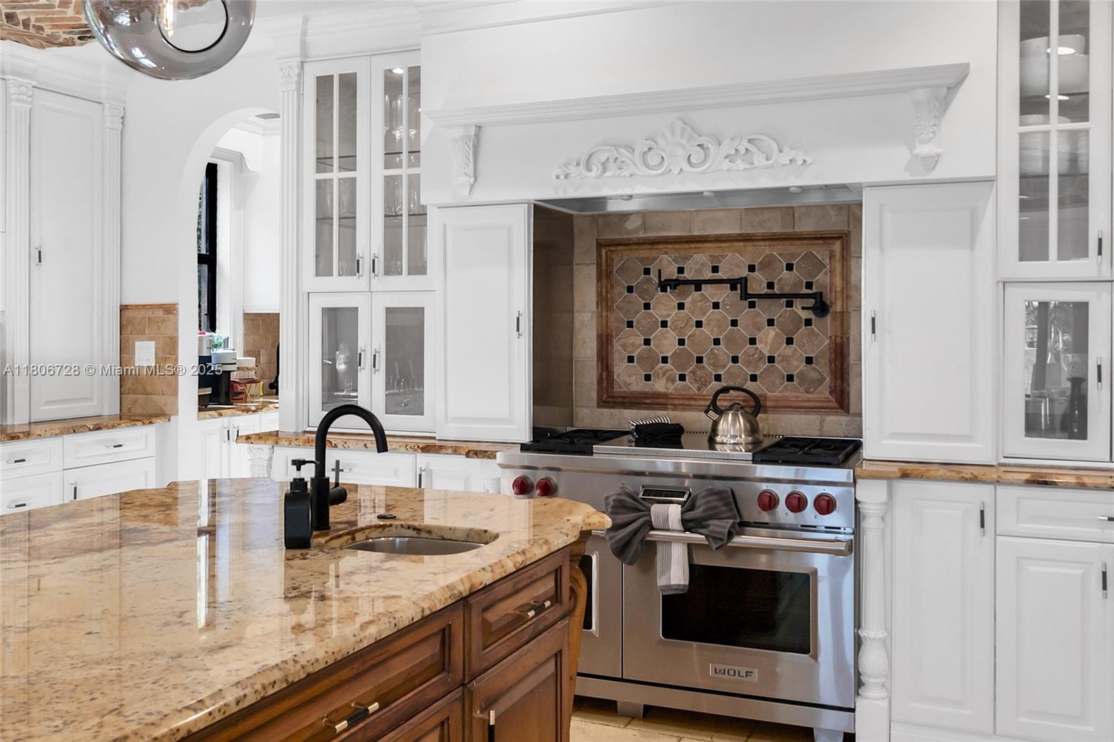 1011 Rhodes Villa Avenue Delray Beach, FL 33483 - Photo 25 of 90 a kitchen with a stove and a sink
