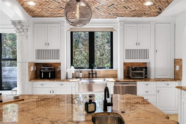 a bedroom with a large bed and a painting on the wall