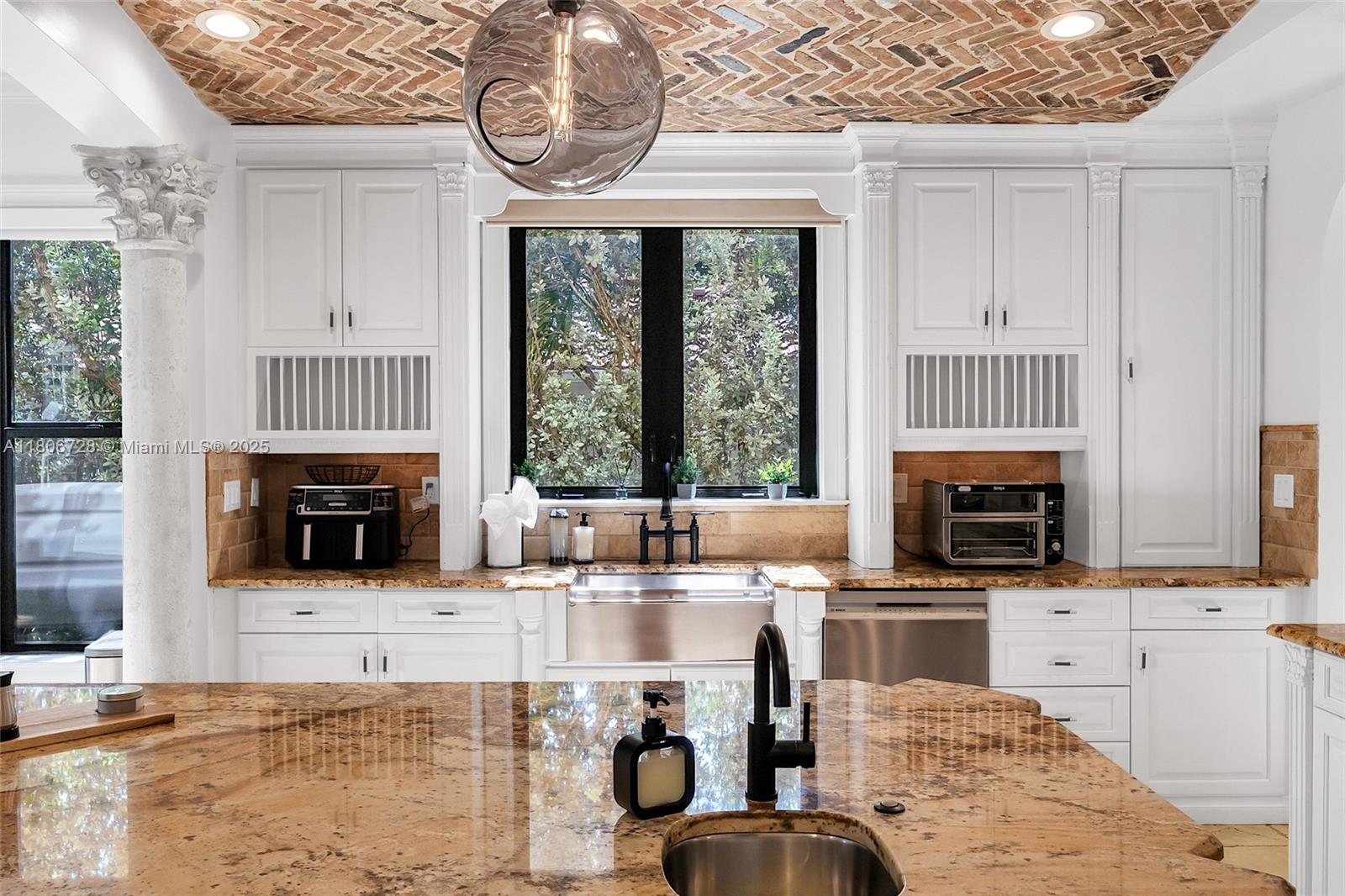 1011 Rhodes Villa Avenue Delray Beach, FL 33483 - Photo 27 of 90 a kitchen with stainless steel appliances a stove a sink and a microwave