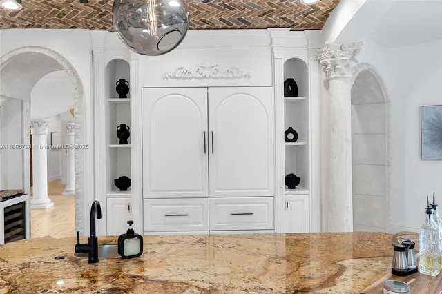 a bathroom with a granite countertop toilet a sink and a mirror