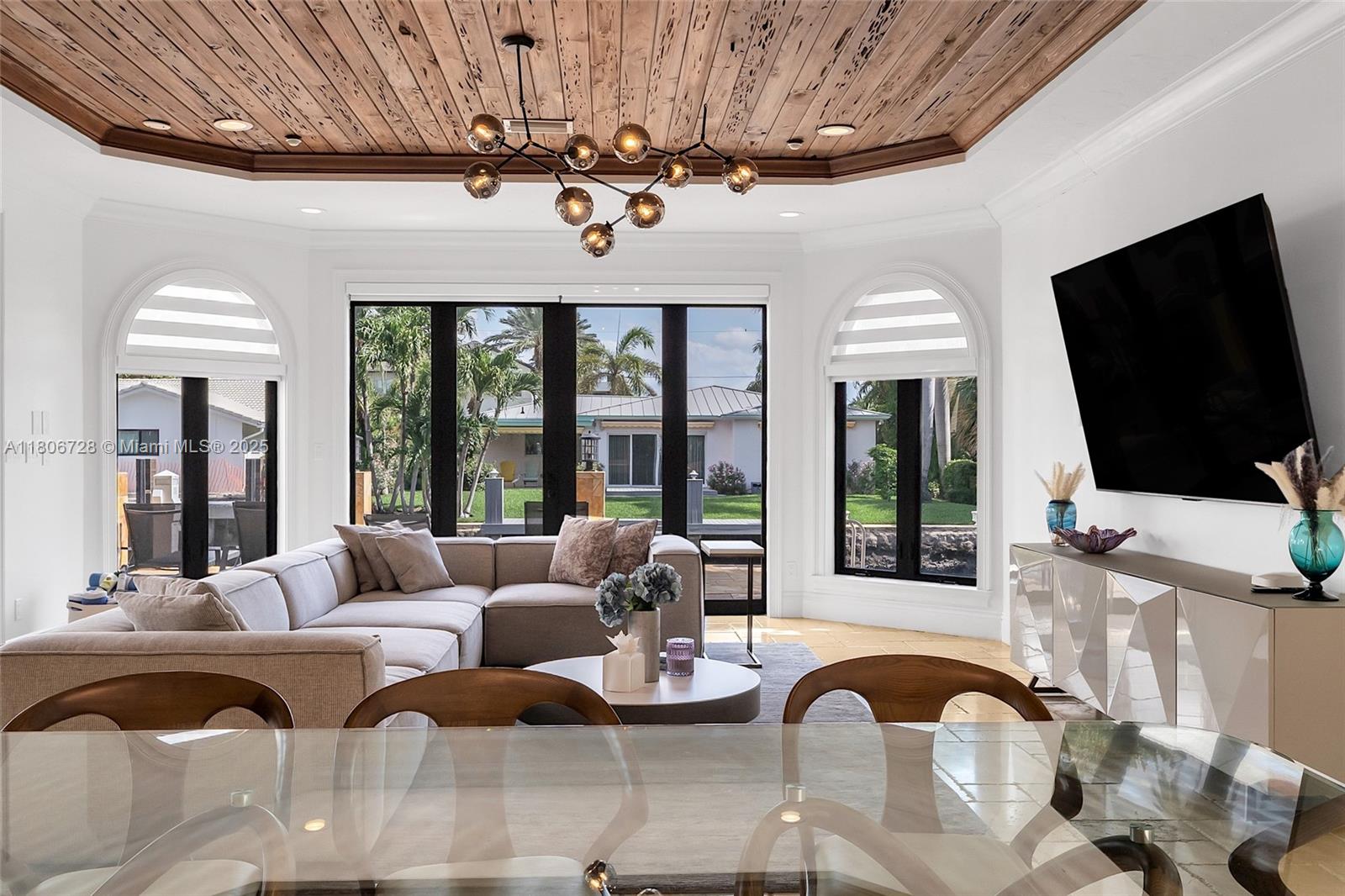 1011 Rhodes Villa Avenue Delray Beach, FL 33483 - Photo 33 of 90 a living room with furniture a flat screen tv and a large window