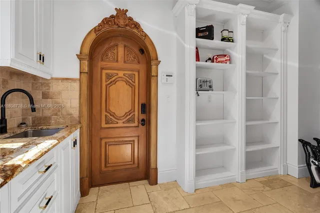a bathroom with a granite countertop toilet a sink a mirror a vanity and a window