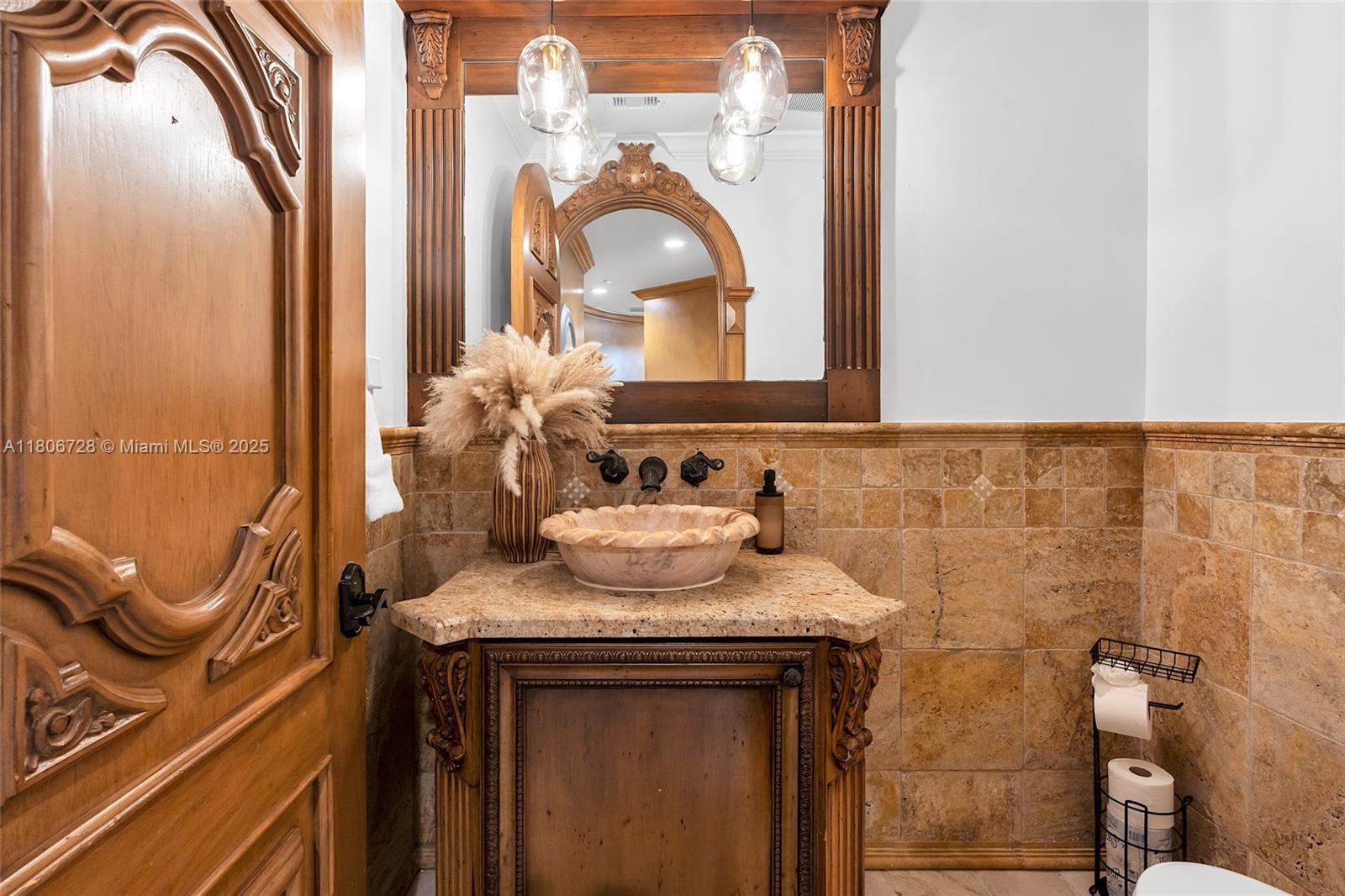 1011 Rhodes Villa Avenue Delray Beach, FL 33483 - Photo 42 of 90 a bathroom with a granite countertop sink a mirror and vanity