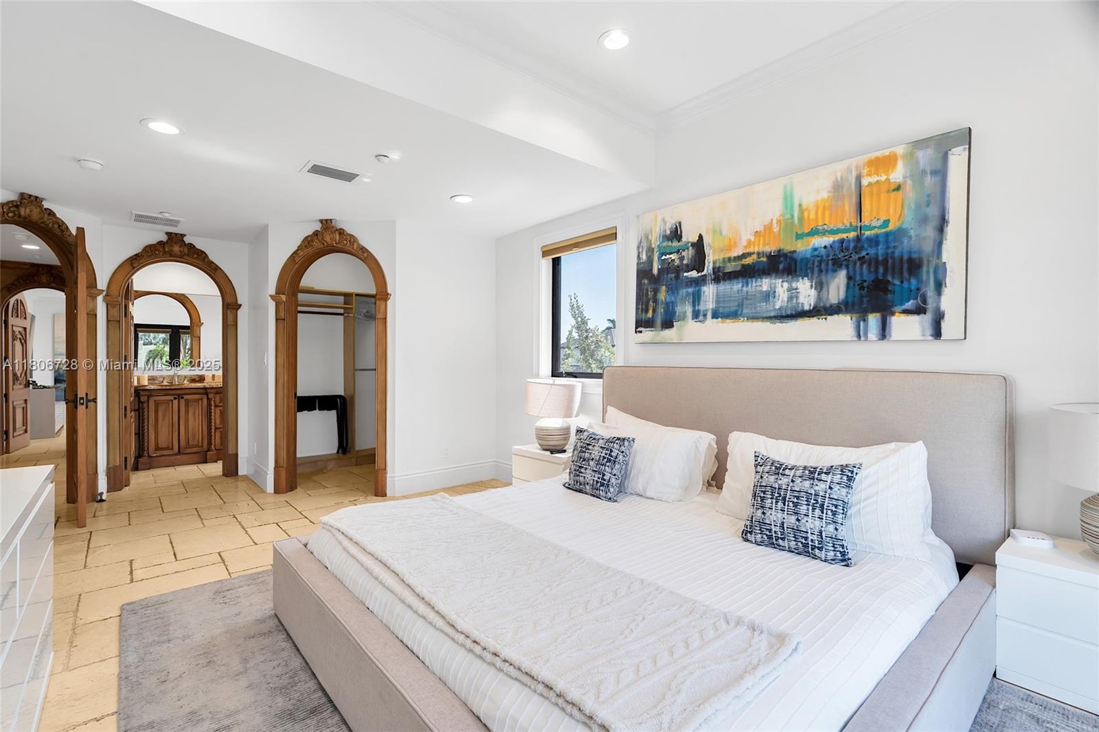 1011 Rhodes Villa Avenue Delray Beach, FL 33483 - Photo 50 of 90 a bedroom with a large bed and a painting on the wall