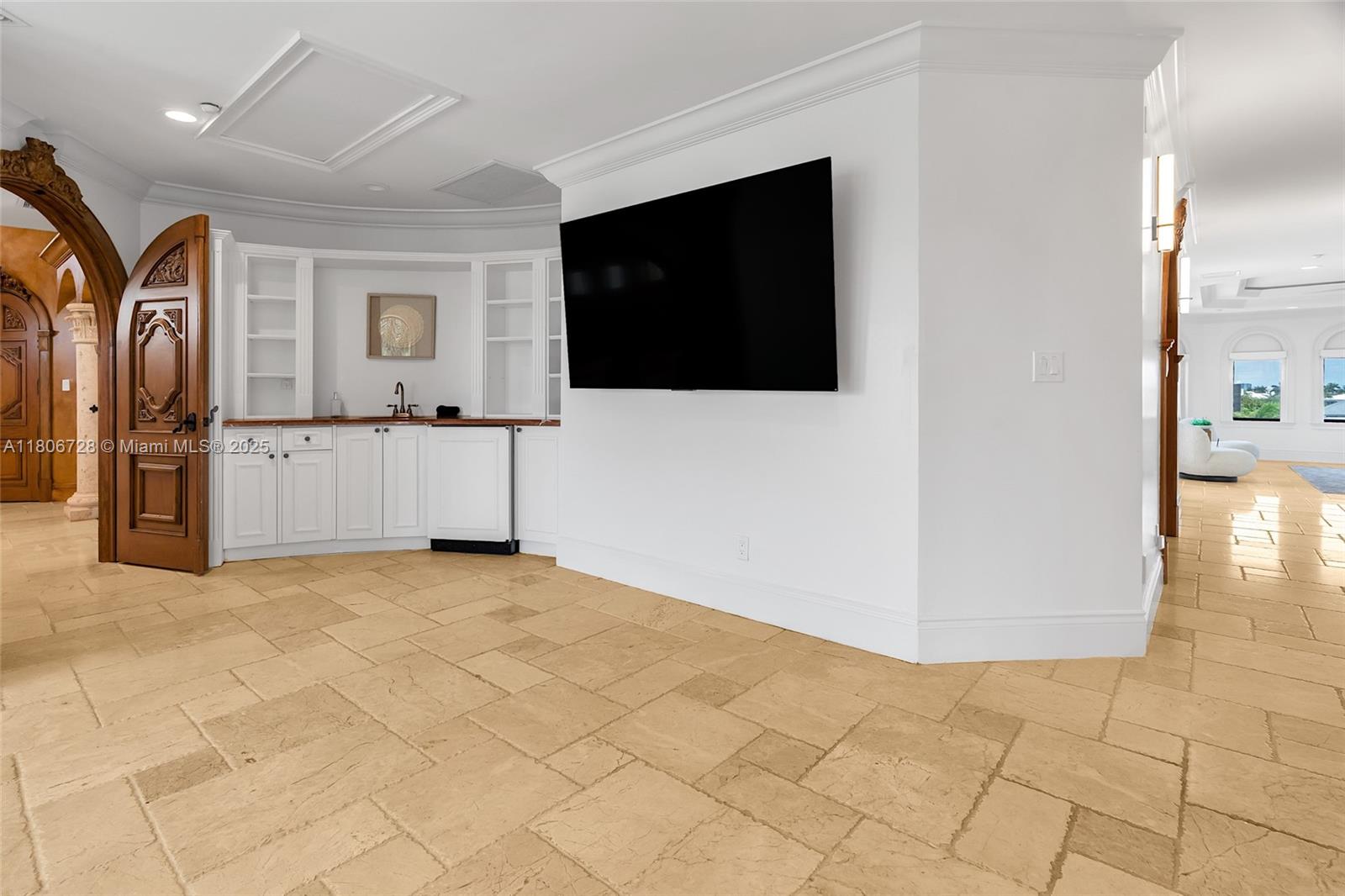 1011 Rhodes Villa Avenue Delray Beach, FL 33483 - Photo 74 of 90 a view of a livingroom with an empty space and a kitchen