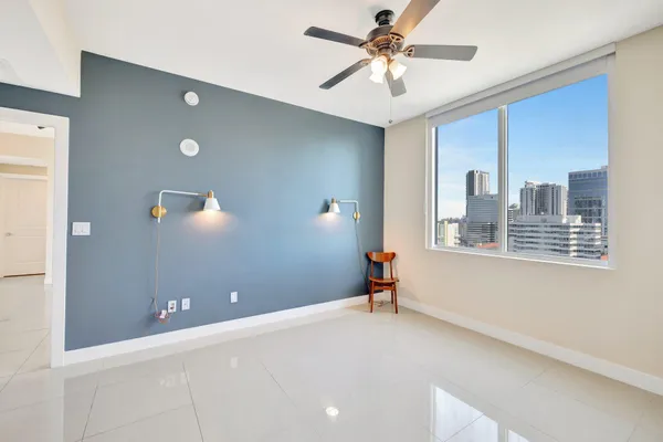 a view of a room with a ceiling fan and a window